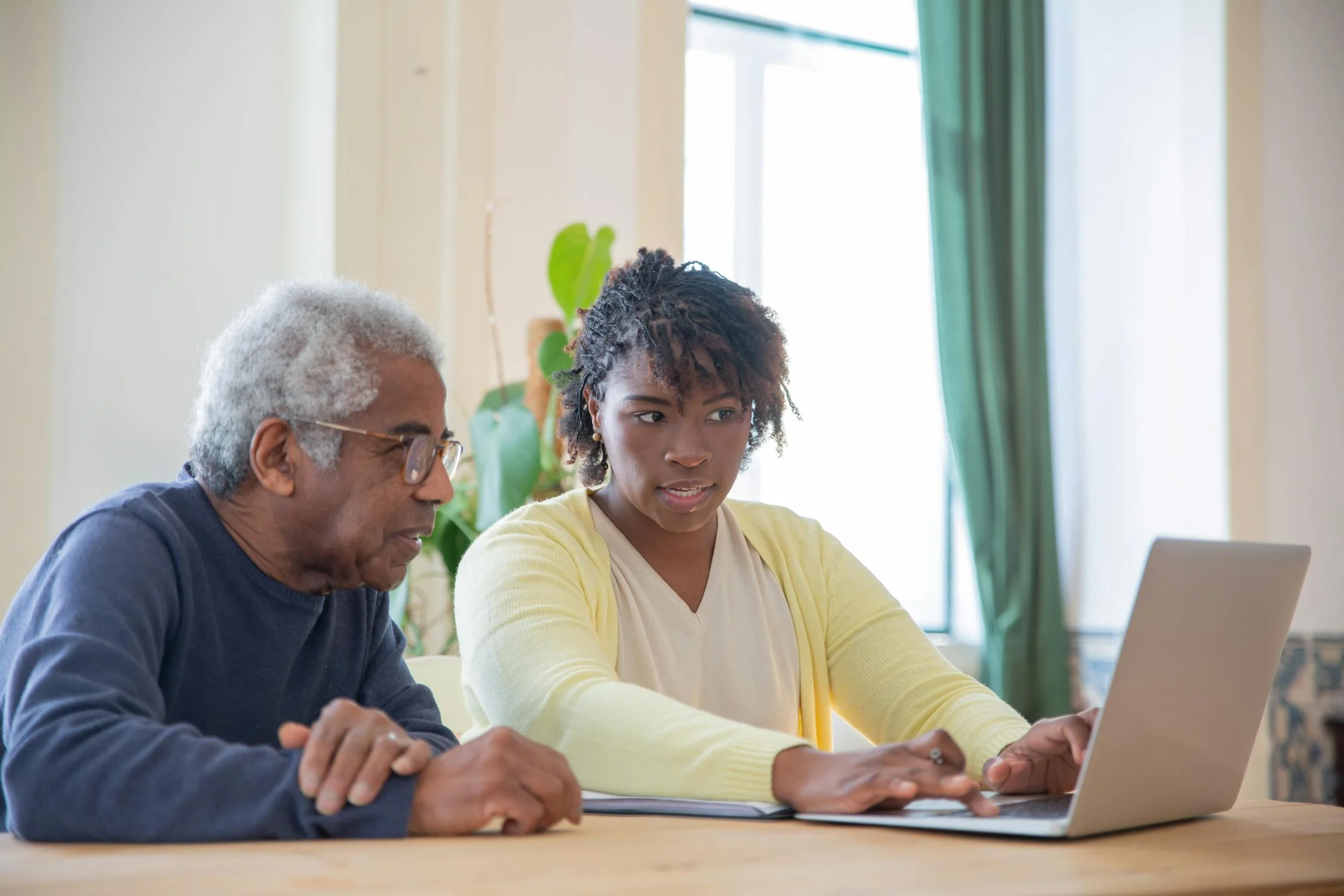 Caregiver supporting a happy elderly woman